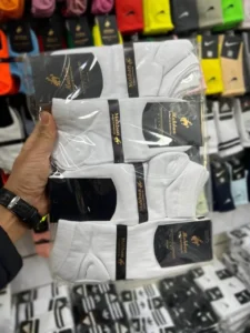 یک جین جوراب مچی ساده سفید 12 جفتی در دست